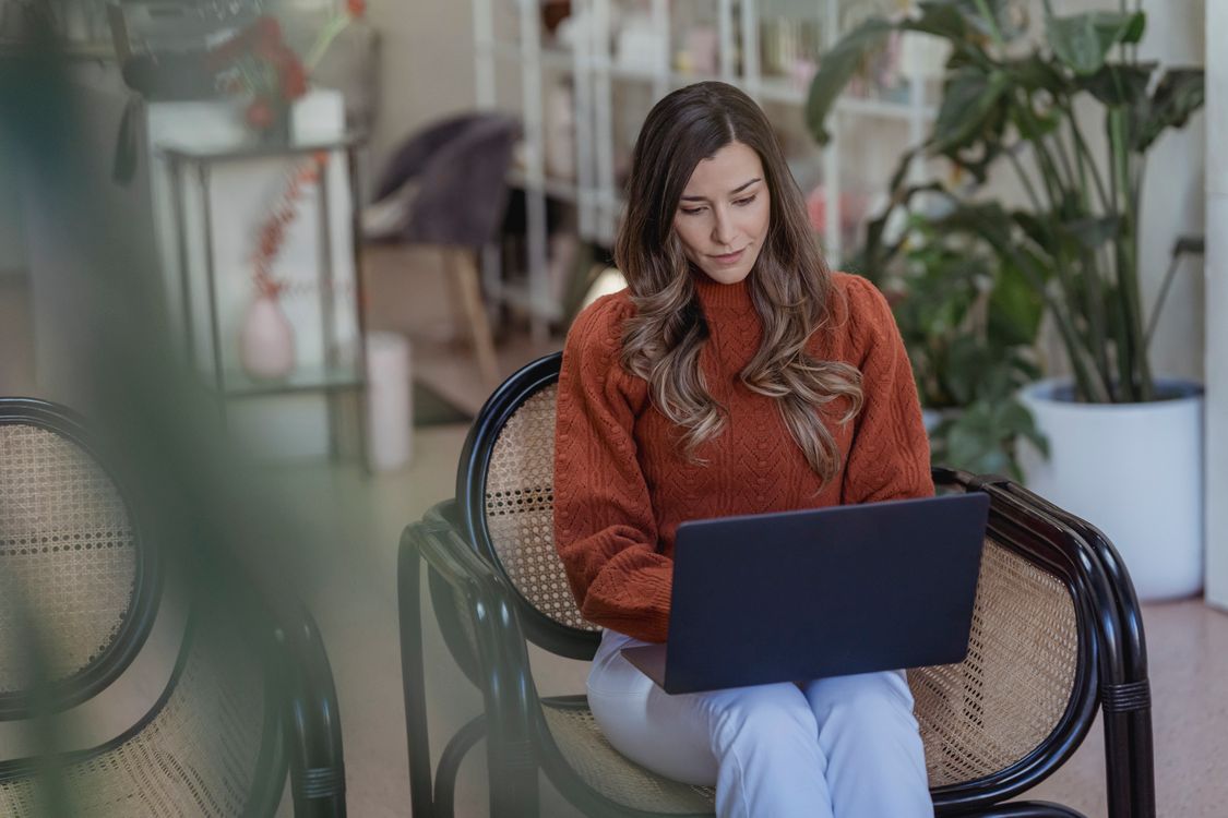 Woman working independently on her laptop in a shared workspace